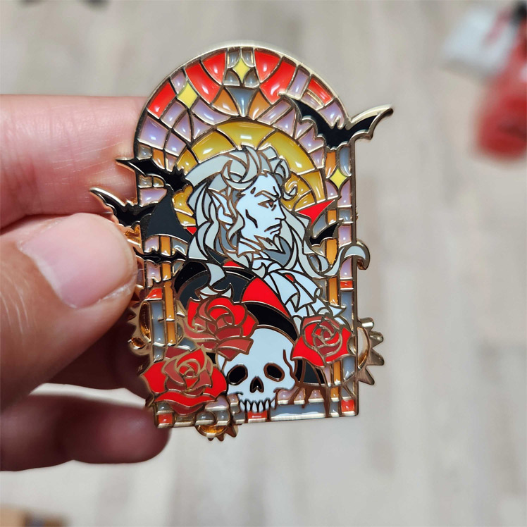 Photo of the Dracula enamel pin under normal lighting.