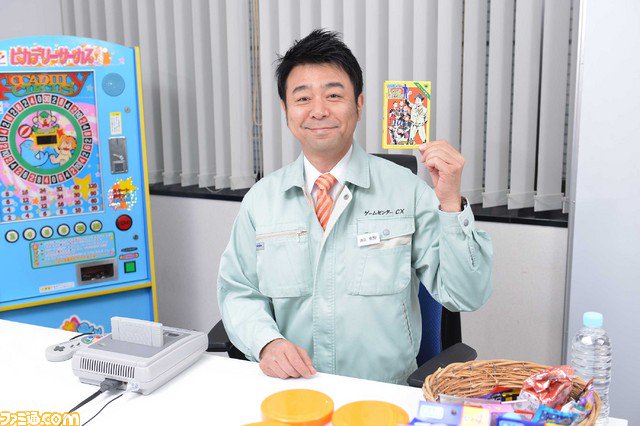 Chief Arino of Game Center CX holding up the Love Letter game box.