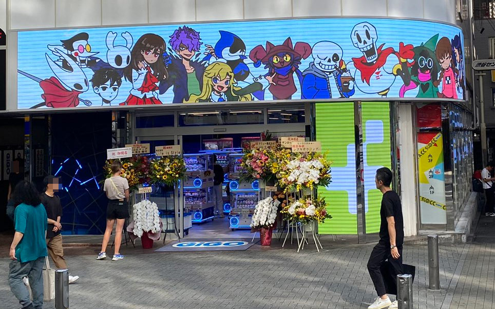 A photo of the exterior of the GiGO arcade building. A large LED sign displays my artwork.